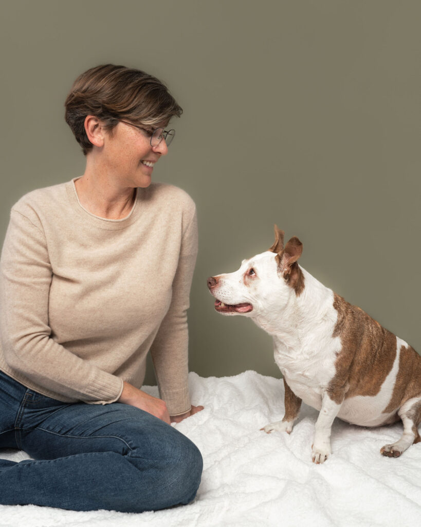 Senior dog and owner sharing stillness during a studio photography session