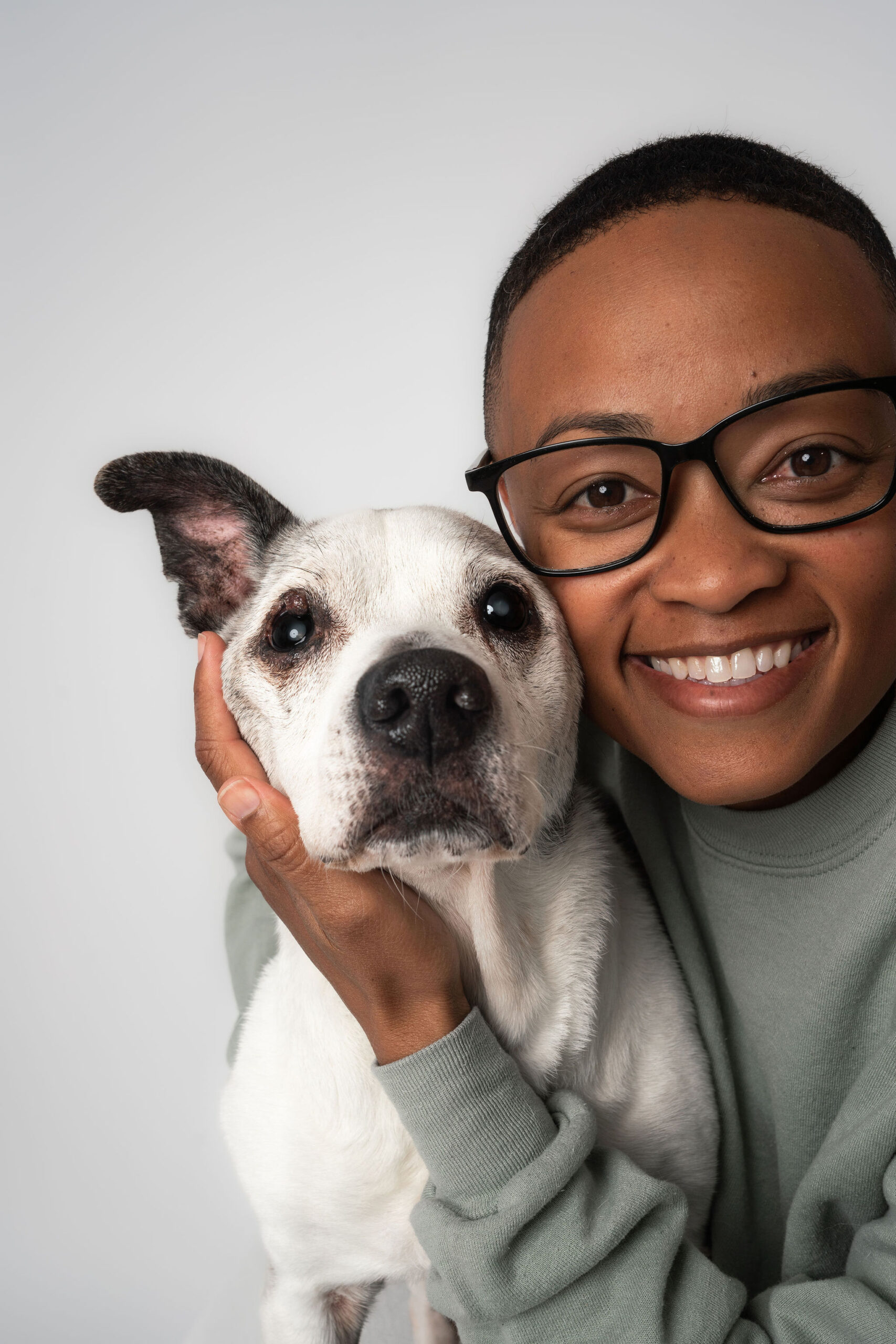 Woman hugging her senior dog during a family photos with dogs San Diego photography studio session close up
