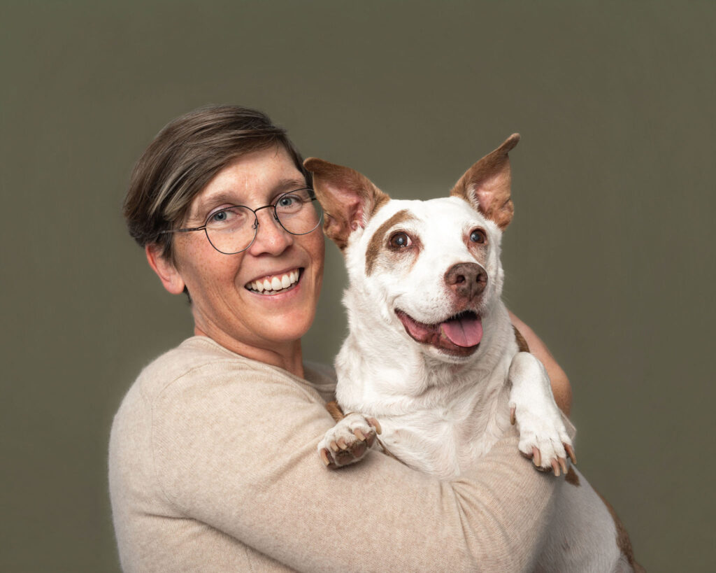 Dog mom holding her senior dog close during a studio photography session