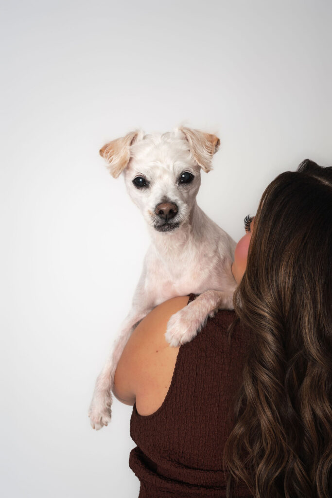 Small dog resting on shoulder during San Diego dog mom photography session