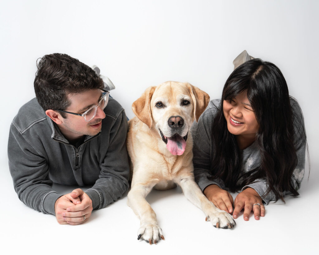 San Diego family portrait featuring a dog and its people photographed together in a professional studio